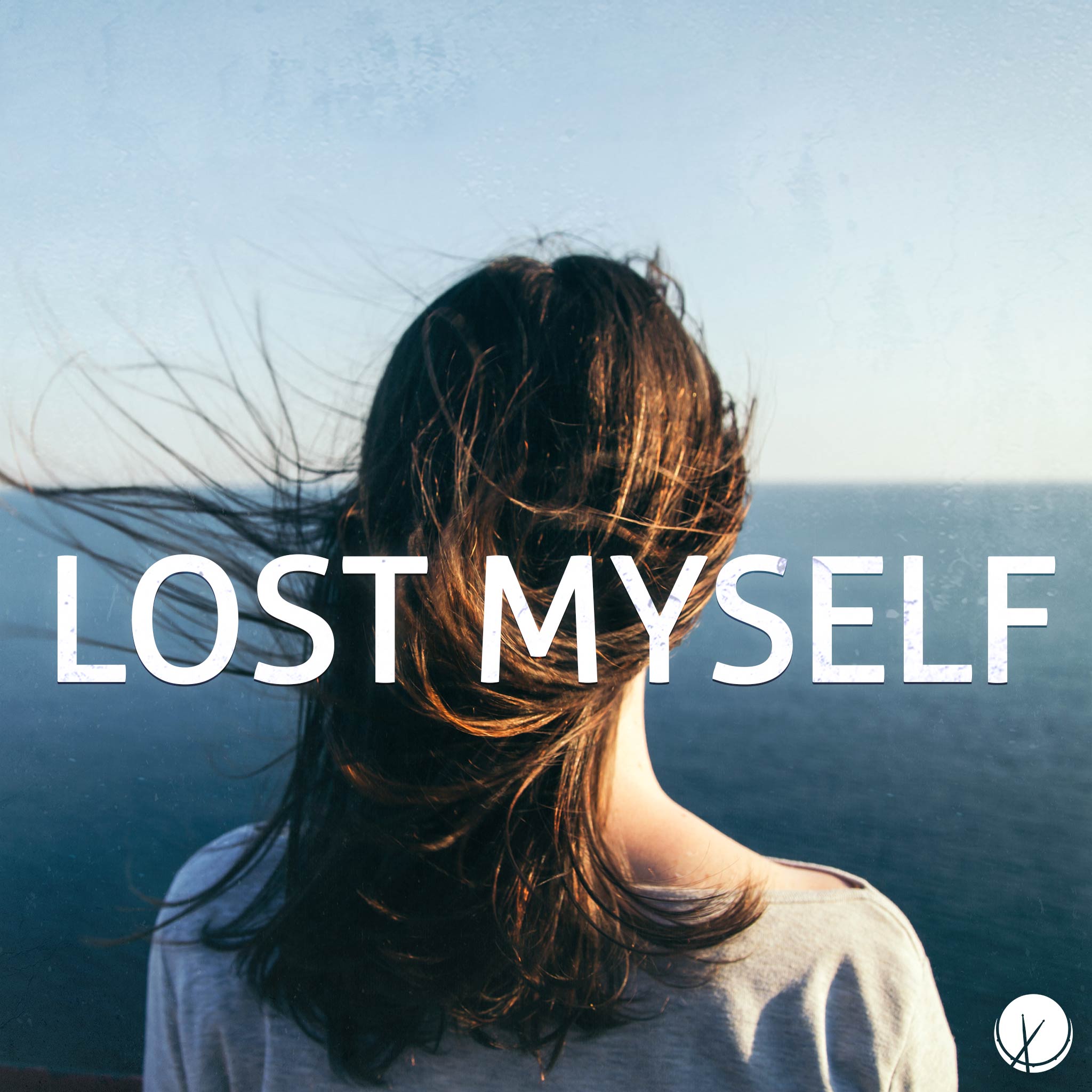Woman looking out at the sea during the daytime, brunette, grey sweater. Title: "Lost Myself."