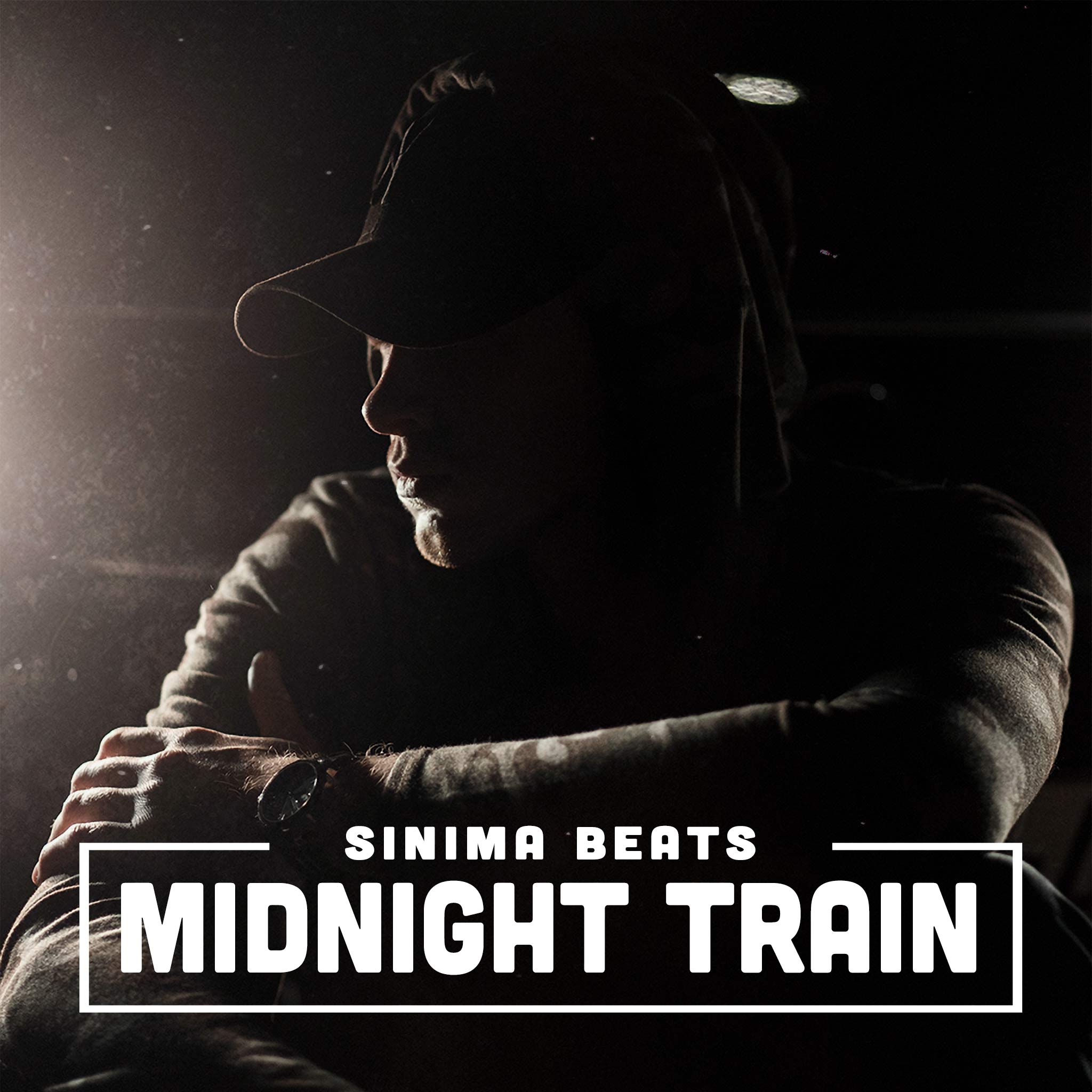 Powerful visual of a Caucasian rapper rocking a baseball cap, seated with arms folded in front of a car under the midnight sky. The darkness and dim lighting set the mood, creating a striking, moody aesthetic. - Midnight Train by Sinima Beats