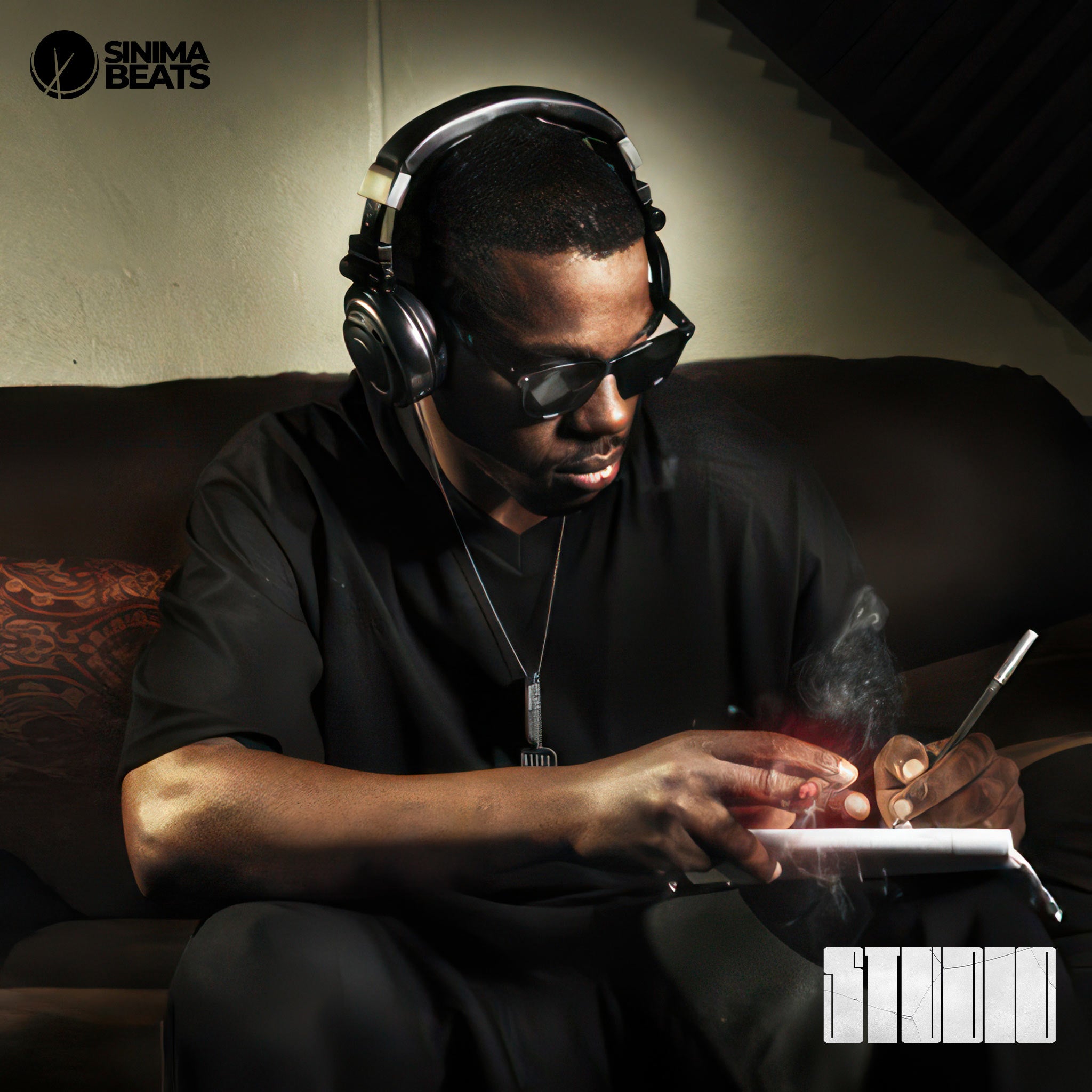A black recording artist is seated in a studio, fully immersed in his craft, capturing the essence of studio vibes. Wearing a black shirt and pants, complemented by a silver chain, the artist holds a cigar in one hand while writing lyrics on a notepad with the other. He listens intently to a rap instrumental through his headphones, channeling inspiration as he writes. The studio ambiance, with dim lighting and audio equipment visible in the background, emphasizes a focused and creative atmosphere. 