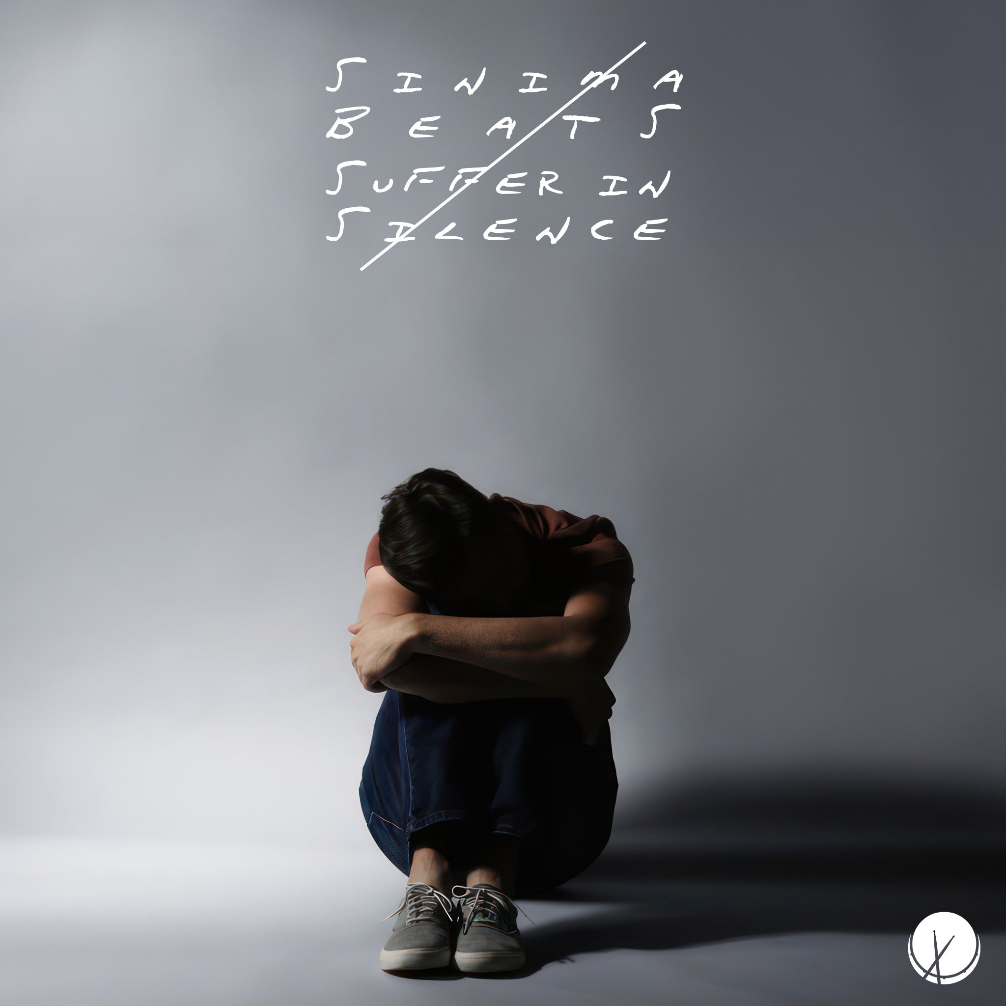 In the image titled Suffer in Silence, a man is shown sitting on the floor with his arms folded and his head bowed, embodying a deep sense of despair. He is dressed in blue jeans, dark gray sneakers, and a burgundy t-shirt, which contrasts with the gray background that envelops him. The composition highlights his isolation and emotional struggle, with his posture and subdued clothing colors emphasizing the theme of silent suffering and internal conflict.